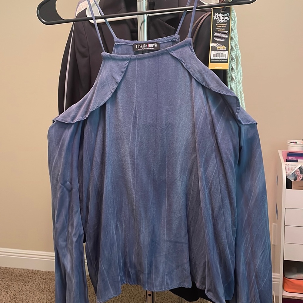 Peekaboo shoulders, ruffle detailing, denim color blouse